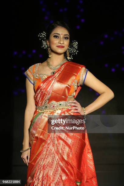 Indian model wearing an elegant and ornate Kanchipuram saree during a South Asian bridal fashion show held in Scarborough, Ontario, Canada.