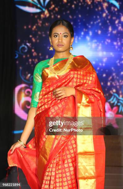 Indian model wearing an elegant and ornate Kanchipuram saree during a South Asian bridal fashion show held in Scarborough, Ontario, Canada.