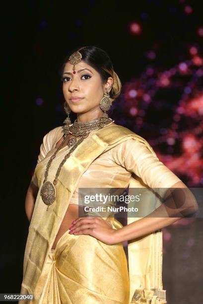 Indian model wearing an elegant and ornate Kanchipuram saree during a South Asian bridal fashion show held in Scarborough, Ontario, Canada.