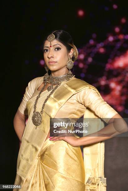 Indian model wearing an elegant and ornate Kanchipuram saree during a South Asian bridal fashion show held in Scarborough, Ontario, Canada.