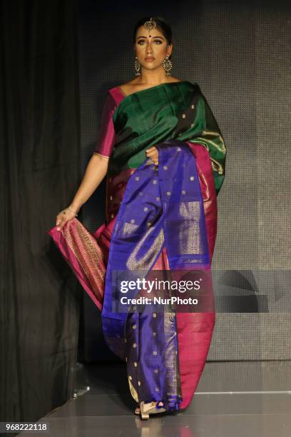 Indian model wearing an elegant and ornate Kanchipuram saree during a South Asian bridal fashion show held in Scarborough, Ontario, Canada.