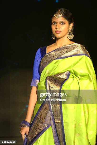 Indian model wearing an elegant and ornate Kanchipuram saree during a South Asian bridal fashion show held in Scarborough, Ontario, Canada.