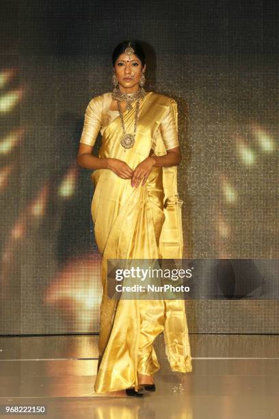 Indian model wearing an elegant and ornate Kanchipuram saree during a South Asian bridal fashion show held in Scarborough, Ontario, Canada.
