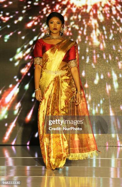 Indian model wearing an elegant and ornate Kanchipuram saree during a South Asian bridal fashion show held in Scarborough, Ontario, Canada.