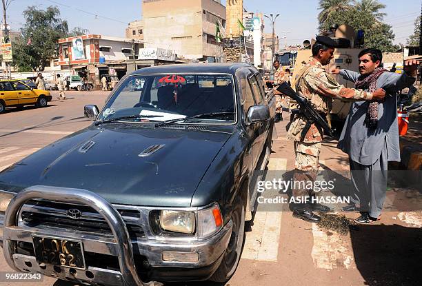 Pakistani paramilitary soldier searches a commuter by the side of the street in Karachi on February 18, 2010. The arrest of a top Taliban commander...