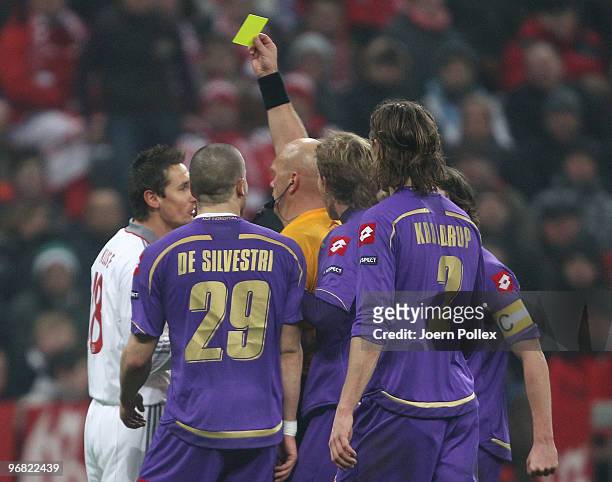 Miroslav Klose of Bayern gets a yellow card from Referee Tom Henning Ovrebo during the UEFA Champions League round of sixteen, first leg match...