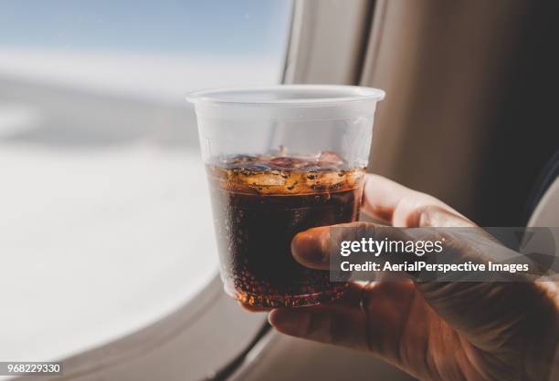 drinking glass by airplane window - cola stock pictures, royalty-free photos & images