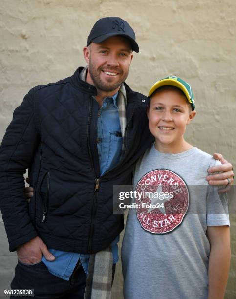 Year-old Leo Sadler poses for a portrait with his role model AB de Villiers at his home during an arranged surprise meeting on June 05, 2018 in...