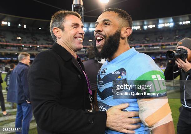 Blues coach Brad Fittler and Josh Addo-Carr of the Blues celebrate winning game one of the State Of Origin series between the Queensland Maroons and...