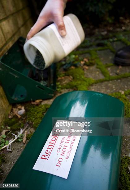 Rentokil pest technician fills an external rat trap with bait in Maidenhead, U.K., on Wednesday, Feb. 17, 2010. Rentokil, based next to England's...