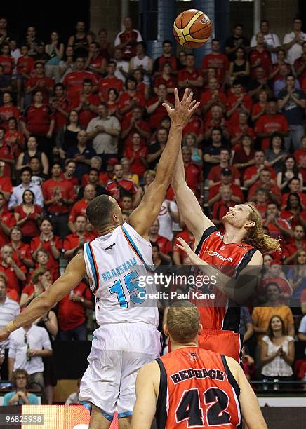 Craig Bradshaw of the Blaze and Luke Schenscher of the Wildcats contest the jump ball during game one of the NBL semi final series between the Perth...