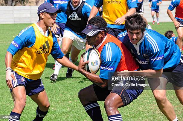 Sireli Naqelevuki is tackled by Jaque Fourie and Gio Aplon during a Stormers Super 14 Training Session at the High Performance Centre in Bellville on...