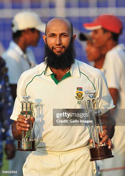 Hashim Amla of South Africa poses with the trophies for Man of the Match and Man of the Series during day five of the Second Test match between India...