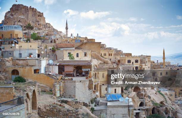 goreme town with mosque and residences in rock formations, cappadocia region, turkey - arman zhenikeyev stock-fotos und bilder