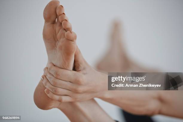 feet of the woman doing yoga exercise - arman zhenikeyev photos et images de collection