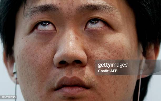 Man controls his mp3 player with his eyes at the Mobile World Congress in Barcelona, on February 18, 2010. The Eye-Controlled Earphones, on show at...