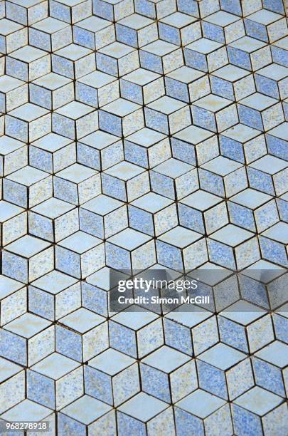 floor tiles in a pastel blue 3d-effect isometric cube pattern - light blue tiled floor stock pictures, royalty-free photos & images