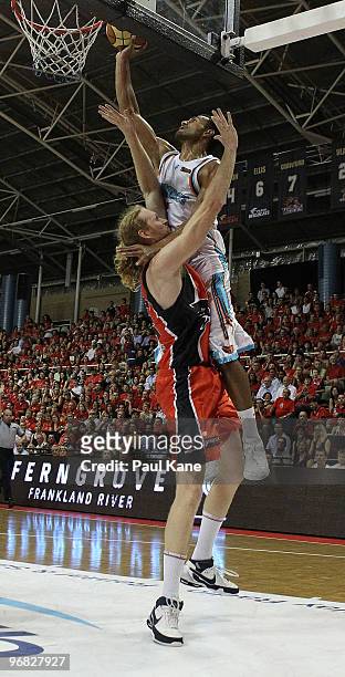 Mika Vukona of the Blaze lays up over Luke Schenscher of the Wildcats during game one of the NBL semi final series between the Perth Wildcats and the...