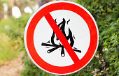 Sign or symbol no campfire, do not light a fire. No Campfires sign, in nature by sea. No open flame sign. No fire, No access with open flame prohibition sign. Red. Forbidden and warning signs access.