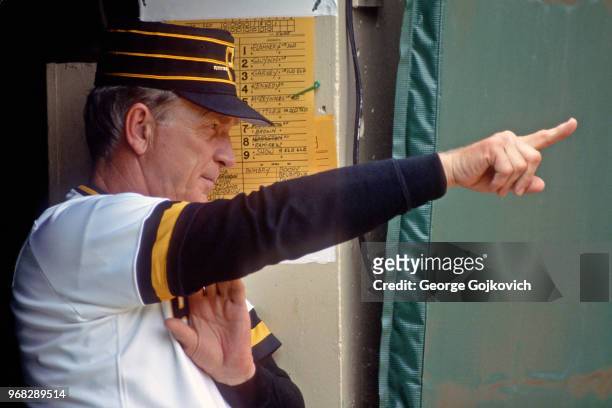 Manager Chuck Tanner of the Pittsburgh Pirates signals from the dugout during a Major League Baseball game against the San Diego Padres at Three...