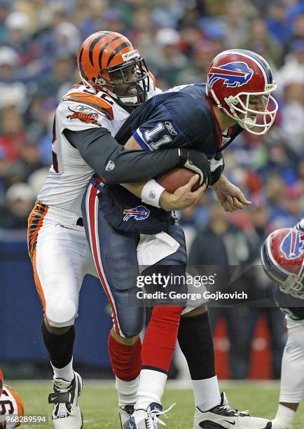 Defensive lineman Duane Clemons of the Cincinnati Bengals sacks quarterback Drew Bledsoe of the Buffalo Bills during a game at Ralph Wilson Stadium...