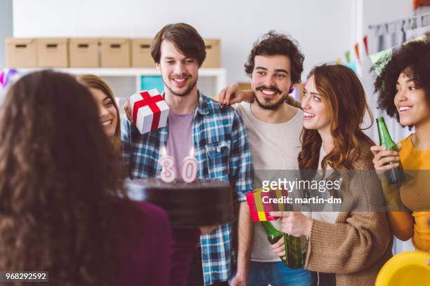 colleagues celebrating birthday party in the office - 30th birthday stock pictures, royalty-free photos & images