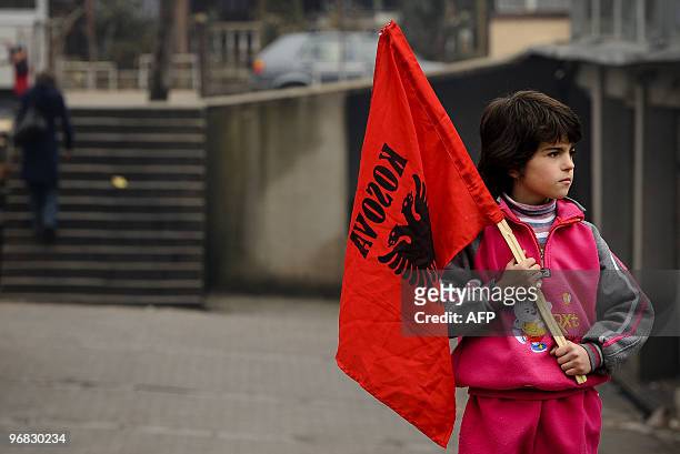 Kosovo Albanian child holds an Albanian flag in the town of Mitrovica on February 17, 2010 as Kosovo today mark the second anniversary of its...