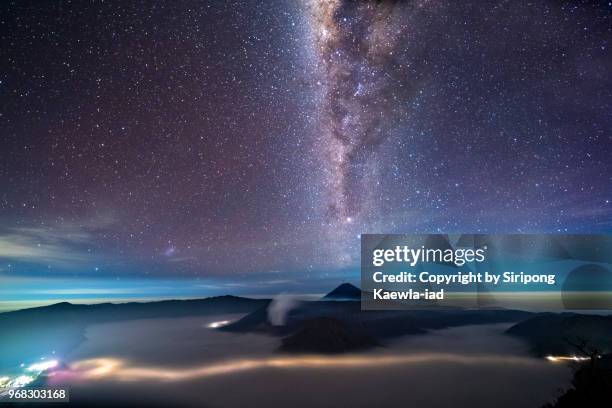 the starry night with the milky way over the mt.semeru, mt.bromo and mt.batok, east java, indonesia. - copyright by siripong kaewla iad stock pictures, royalty-free photos & images