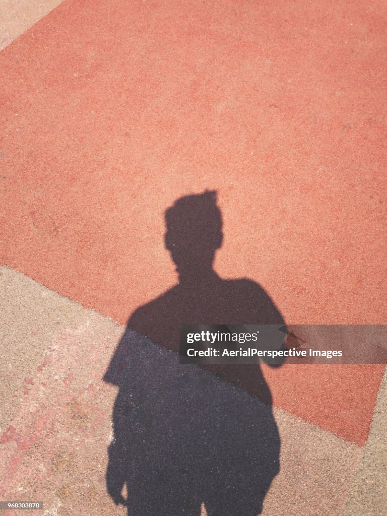 Shadow of a men on street background using Mobile Phone