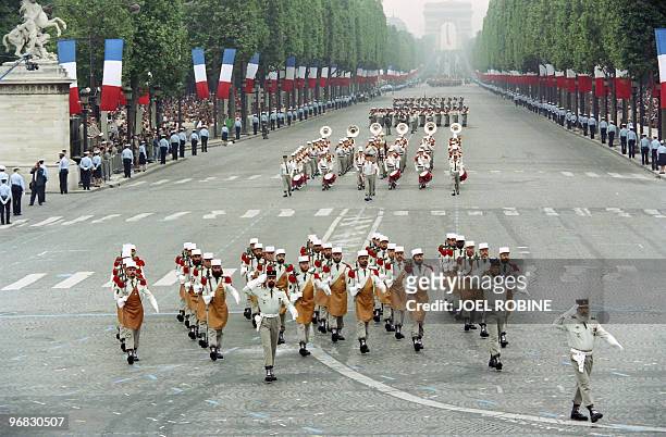 An unit and band of the French Foreign Legion parade from the Arch of Triumph on July 14 during the Bastille day parade en route down the...