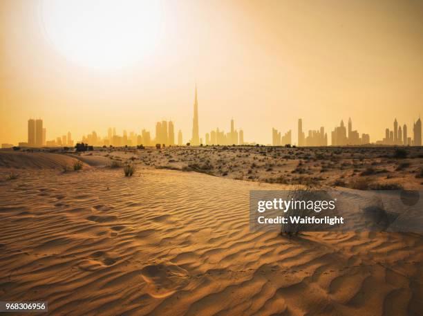 dubai urban skyline in desert - dubai sunset desert stock pictures, royalty-free photos & images