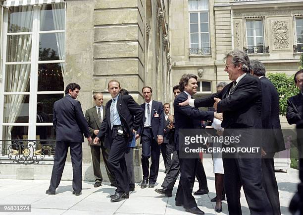 French actor Alain Delon meets with on July 14 during Elysée garden party, with Bernard Tapie, French businessman, politician, occasional actor,...