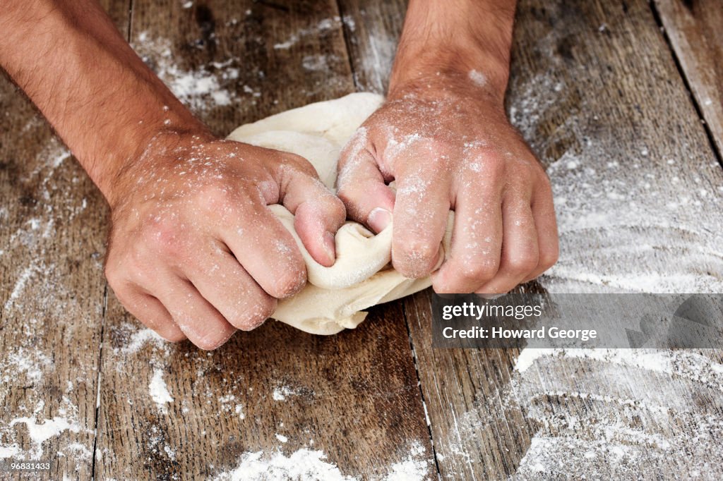 Man kneading bread dough