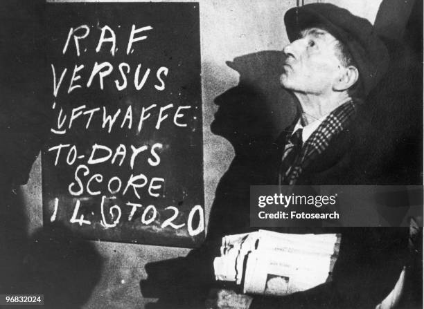 Photograph of a Newspaper Seller in the Street Watching a Dog Fight during the Battle of Britain, circa 1940.