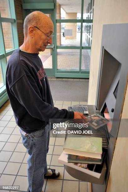 man returning library books at automated kiosk - des plaines stock pictures, royalty-free photos & images
