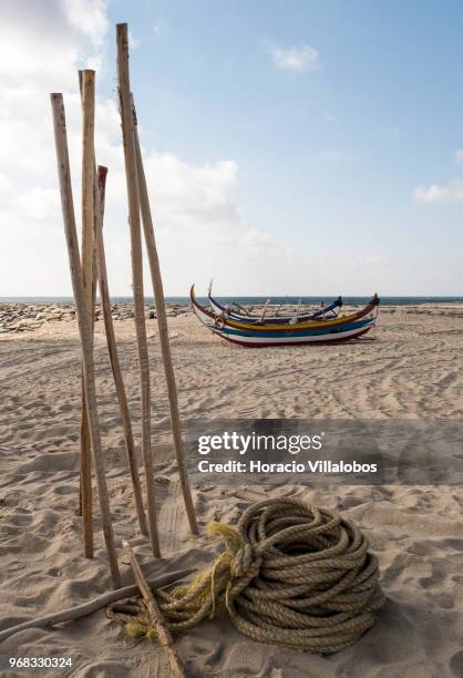 Fishing boats and tools seen on the beach in a Sunday afternoon on May 27, 2018 in Espinho, Portugal. Fishermen do not go out to sea on Sundays and...