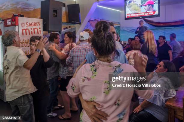 Locals dance in "Casa Pescador" across the street from the beach in a Sunday afternoon on May 27, 2018 in Espinho, Portugal. Fishermen do not go out...