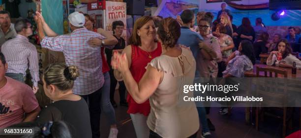 Locals dance in "Casa Pescador" across the street from the beach in a Sunday afternoon on May 27, 2018 in Espinho, Portugal. Fishermen do not go out...