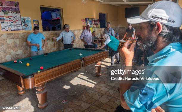 Locals play pool in "Casa Pescador" across the street from the beach in a Sunday afternoon on May 27, 2018 in Espinho, Portugal. Fishermen do not go...