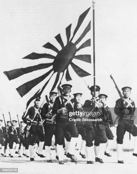 Photograph of Japanese Soldiers Marching holding Bayonettes and Flying the Rising Sun Flag, circa 1945.