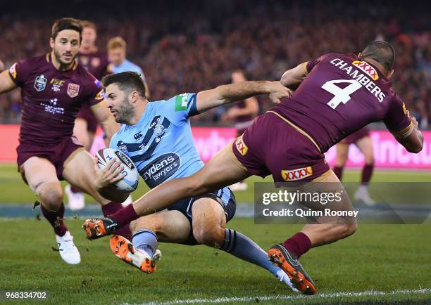 James Tedesco of the Blues is tackled by Will Chambers of the Maroons during game one of the State Of Origin series between the Queensland Maroons...