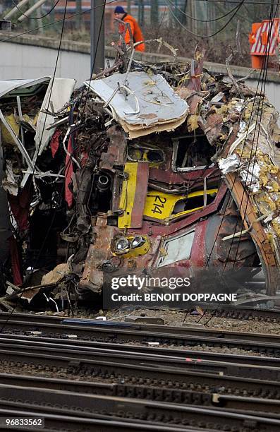 Man views the twisted debris from the wreckages of the two trains that collided last Monday near Buizingen train station, in Halle on February...