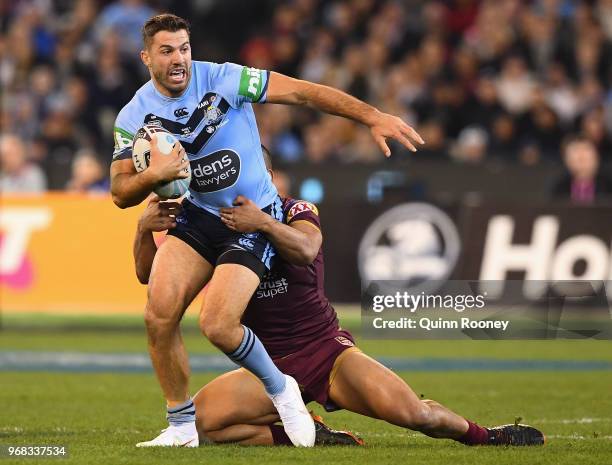 James Tedesco of the Blues is tackled by Will Chambers of the Maroons during game one of the State Of Origin series between the Queensland Maroons...