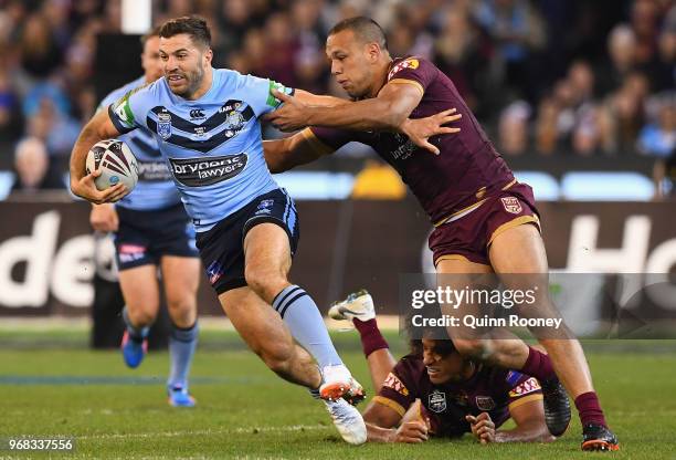 James Tedesco of the Blues is tackled by Will Chambers of the Maroons during game one of the State Of Origin series between the Queensland Maroons...