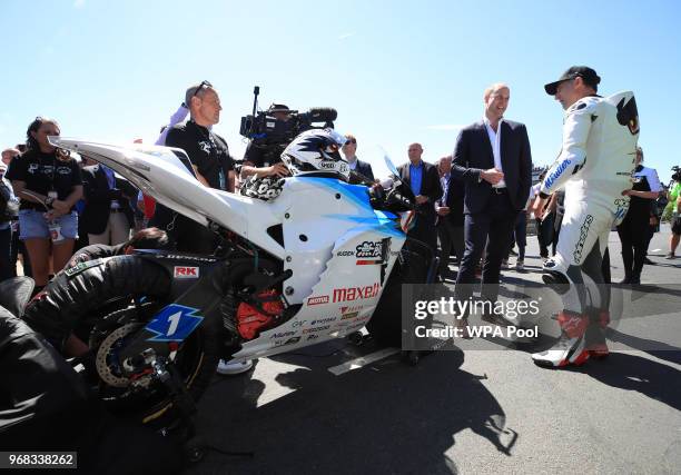 Prince William, Duke of Cambridge is shown a bike by motorcyclist Michael Rutter at the Isle of Man TT on June 6 Isle of Man, United Kingdom.