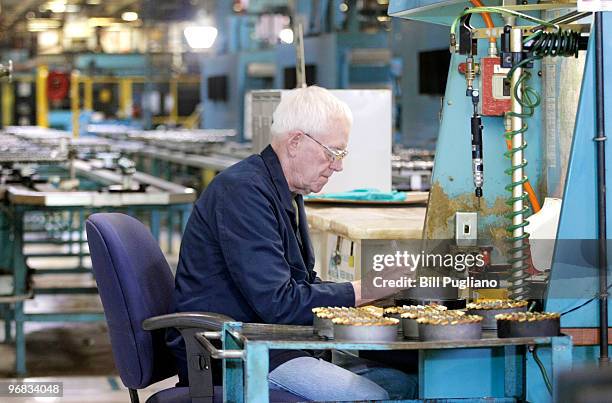 General Motors employee mans his station while working at the GM Bay City Powertrain plant February 18, 2010 in Bay City, Michigan. GM anounced today...