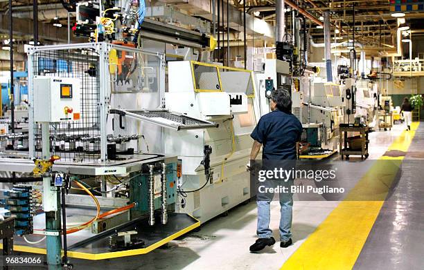 General Motors employees man their stations while working at the GM Bay City Powertrain plant February 18, 2010 in Bay City, Michigan. GM anounced...