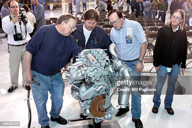 General Motors employees and members of the media look at GM's Ecotec engine after a press conference at the GM Bay City Powertrain plant February...