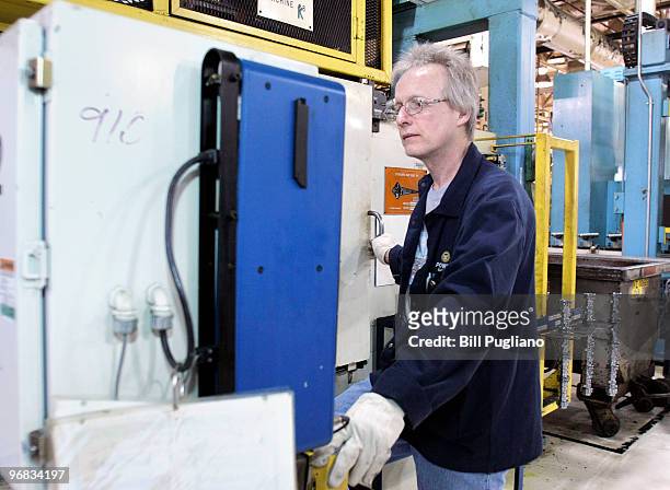 General Motors employee mans his station while working at the GM Bay City Powertrain plant February 18, 2010 in Bay City, Michigan. GM anounced today...