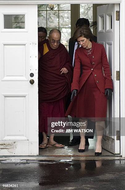 Exiled Tibetan spiritual leader the Dalai Lama walks out the doors of the Palm Room of the White House in Washington, DC, February 18, 2010 after...